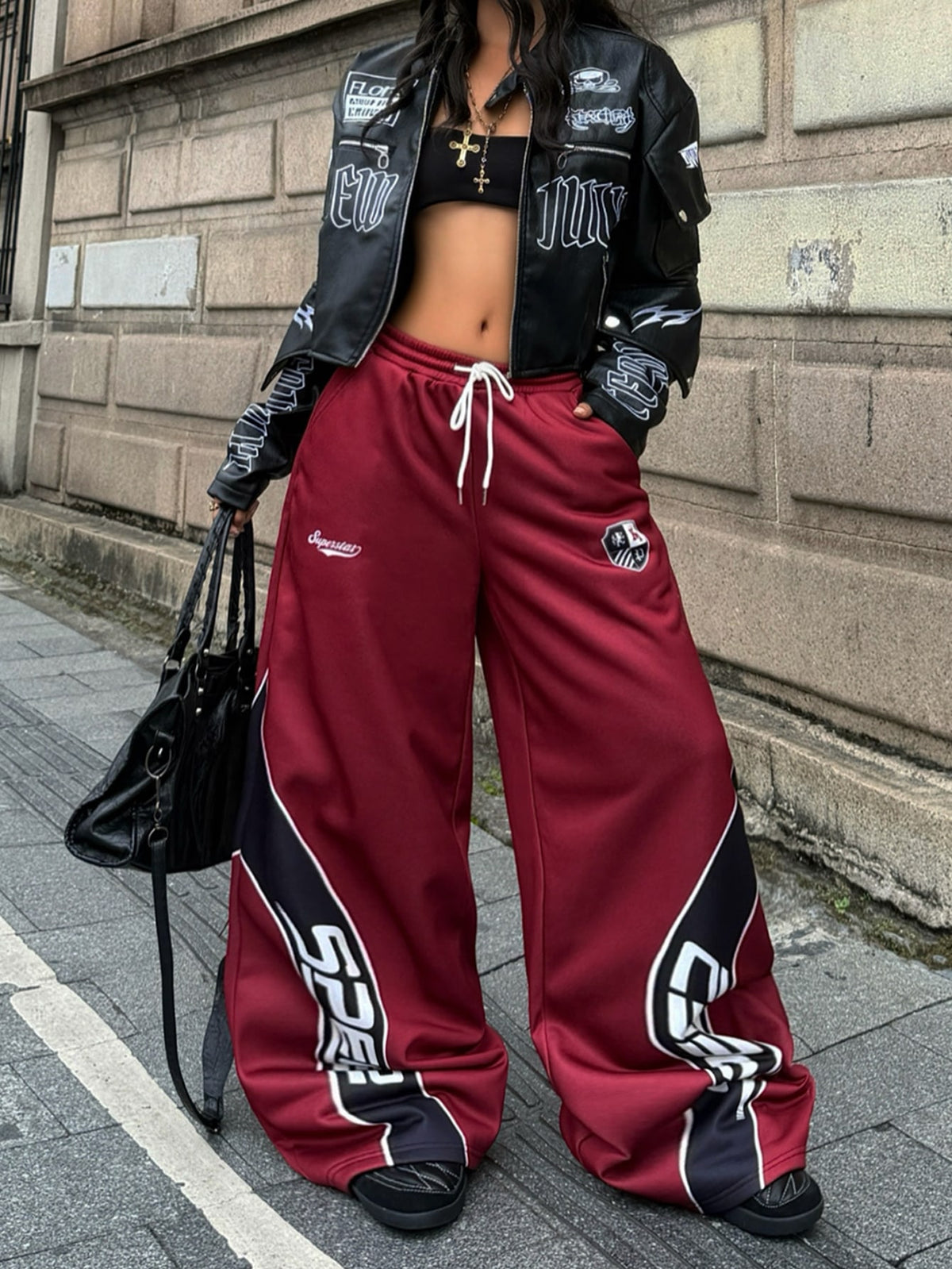 Women's loose fit wide leg graphic sweatpants in light grey with an elastic drawstring waistband