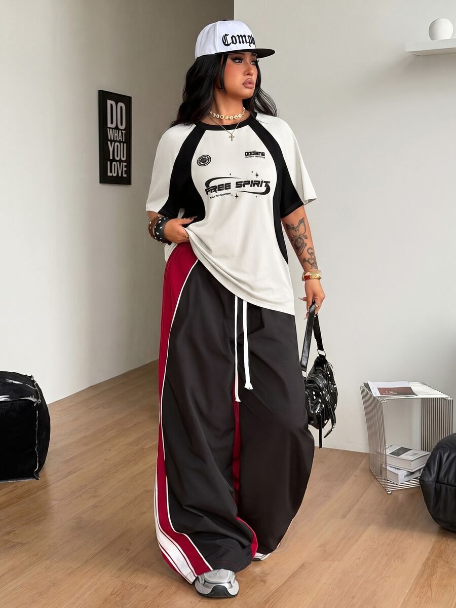 Unisex plus size oversized jersey t-shirt in brown featuring a round neck, short raglan sleeves with contrast binding, and a front letter graphic print.