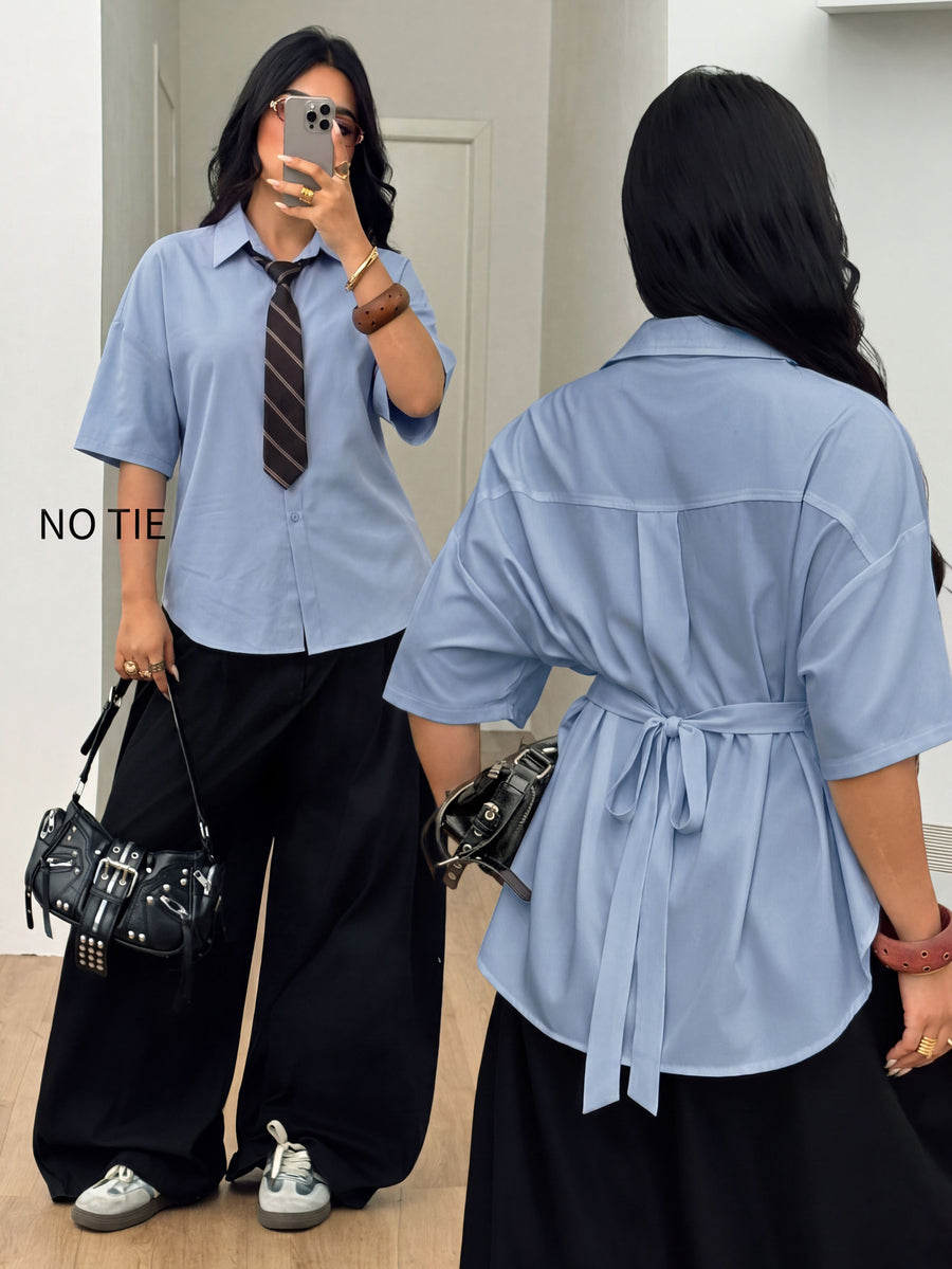 Women's plus size oversized white short sleeve shirt with classic collar, contrast piping, and asymmetrical hem