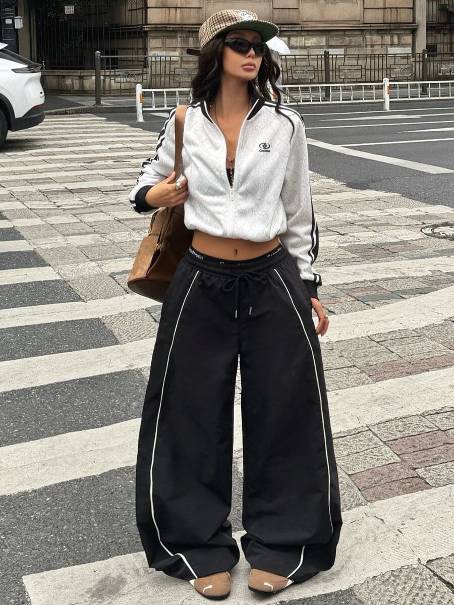 Women's loose fit straight leg pants in black and white with banded texture design, low drawstring waist, and pockets.