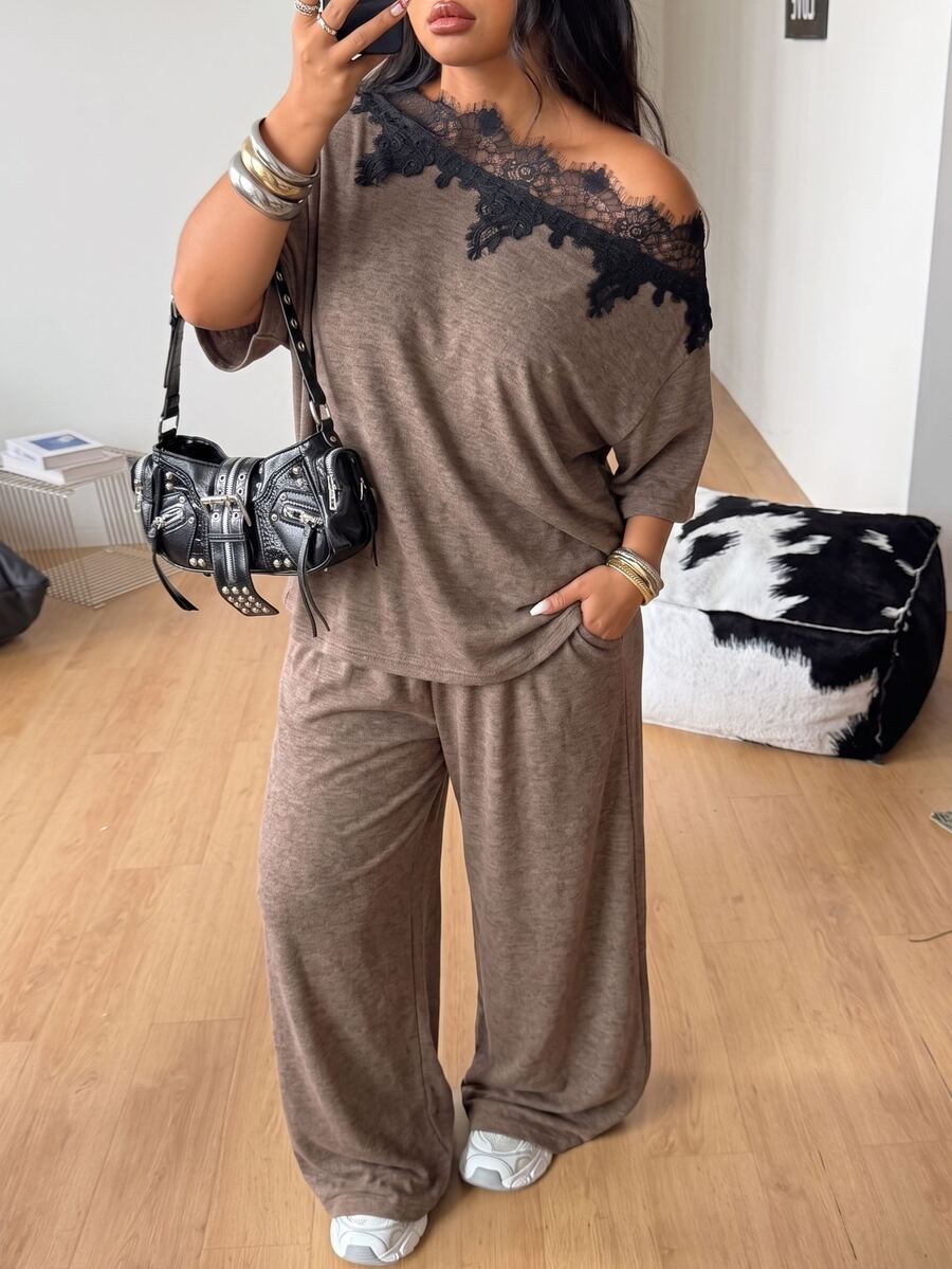 Women's casual two-piece outfit featuring a loose short-sleeve asymmetrical neck t-shirt and matching long wide leg pants with pockets.