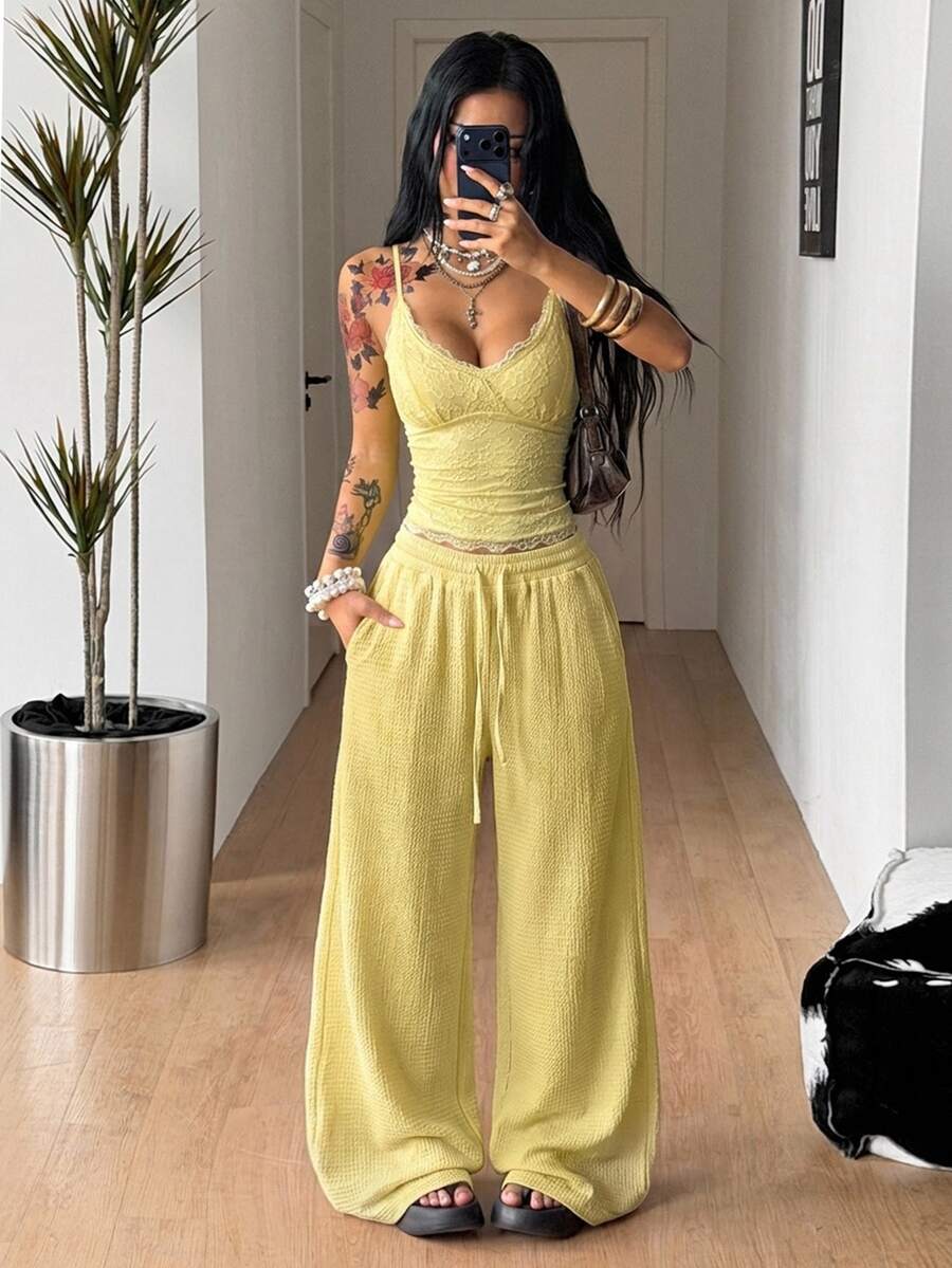Women's loose fit straight leg lounge pants in textured knit fabric featuring an elastic drawstring waist and side pockets