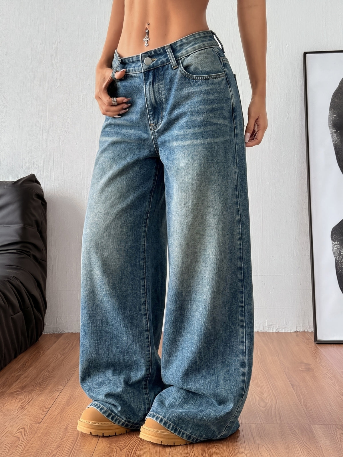 Women's relaxed fit wide leg denim jeans with pockets and a zipper fly.