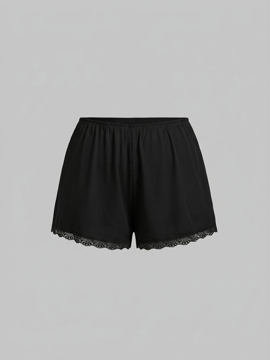Two-piece ribbed pajama set featuring a lace-trimmed crop camisole top with spaghetti straps and matching shorts.
