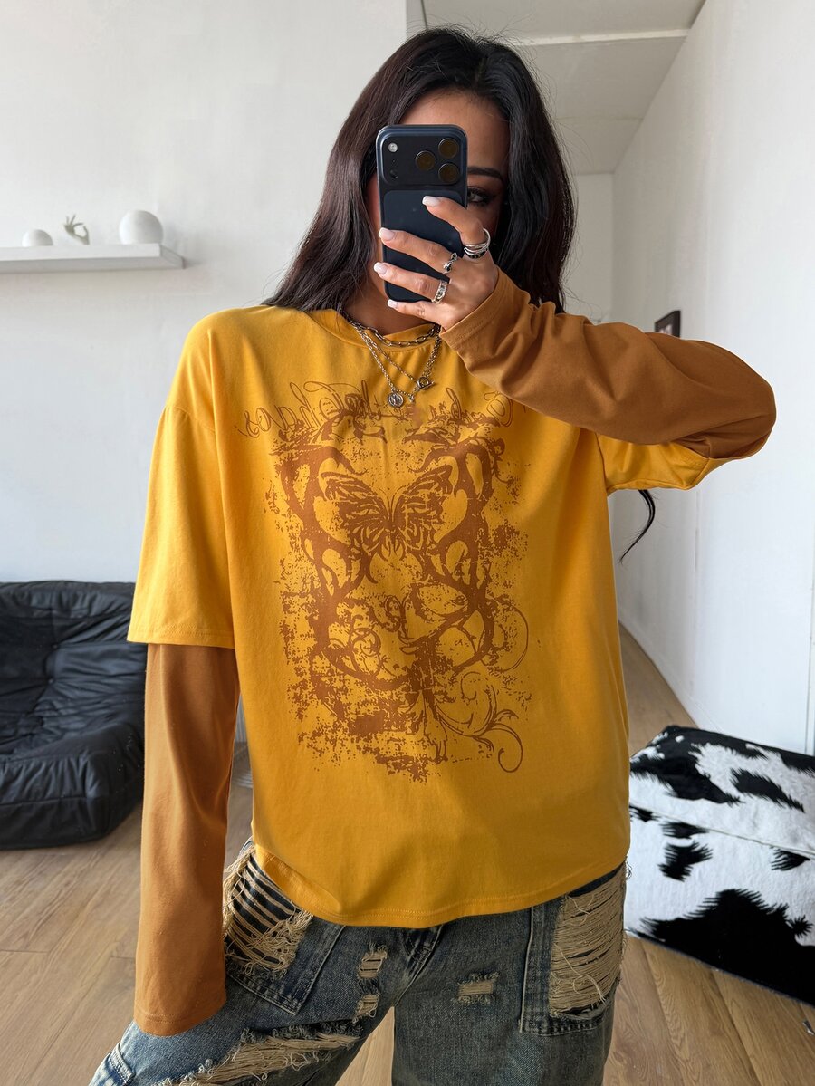 Women's casual graphic long sleeve t-shirt with a round neck, drop shoulder sleeves, and loose relaxed fit.