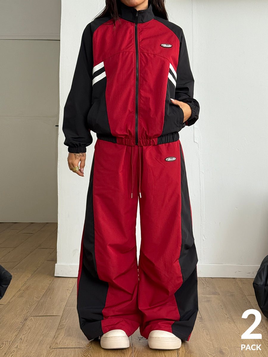 Women's plus size two-piece casual tracksuit set in black, featuring a loose-fit zip-up jacket with stand collar and matching cropped parachute pants.