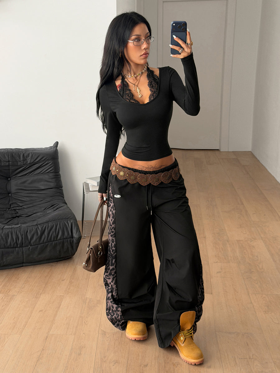 Women's slim fit black halter long sleeve t-shirt with contrast lace detailing and deep v-neckline.