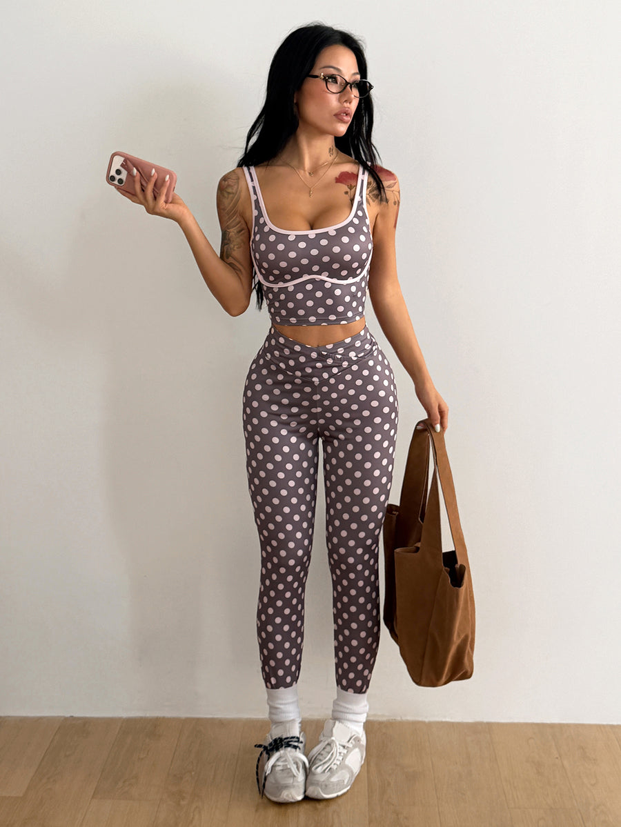 Women's two-piece activewear set featuring a multicolor polka dot backless crop top and matching slim-fit leggings.