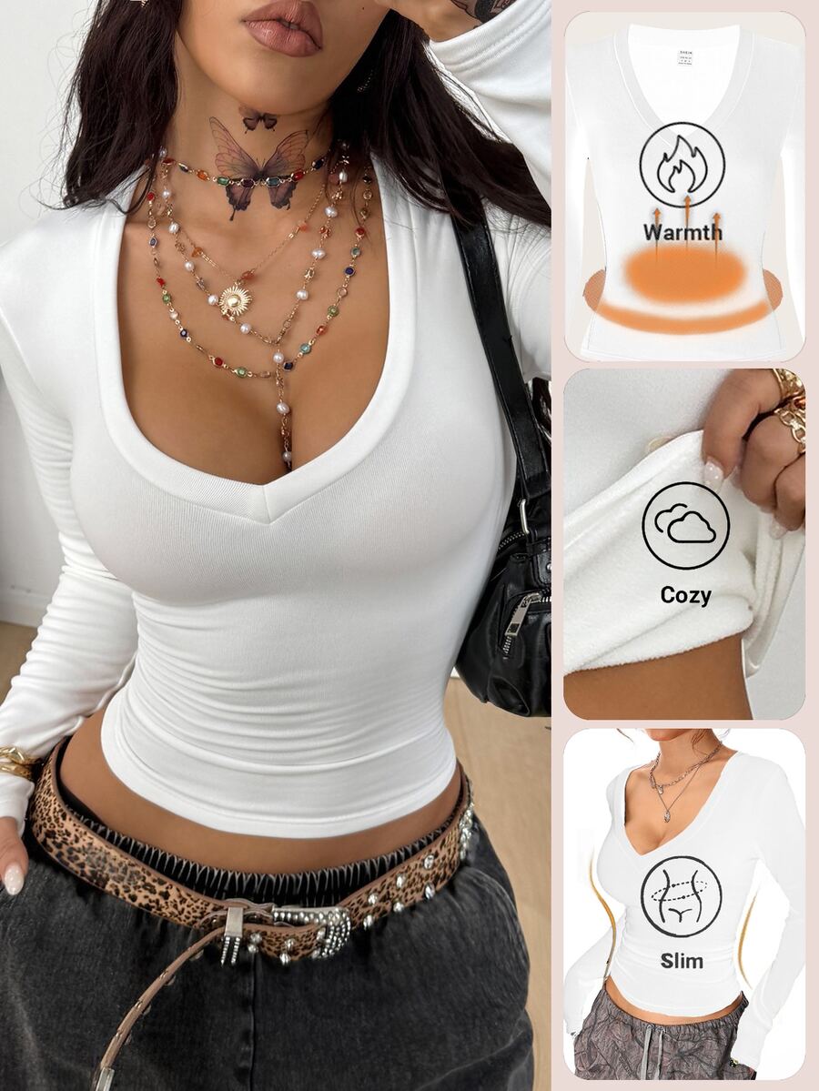 Women's fitted long sleeve rib-knit top featuring a deep V-neckline with delicate contrast lace detailing.
