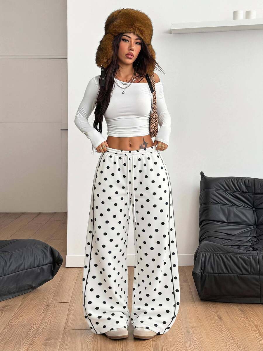 Women's loose fit wide leg graphic sweatpants in light grey with an elastic drawstring waistband