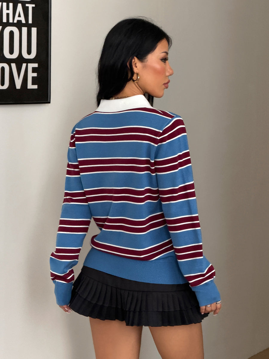 Women's blue and white striped knit polo sweater with button collar and long drop-shoulder sleeves in a relaxed fit.