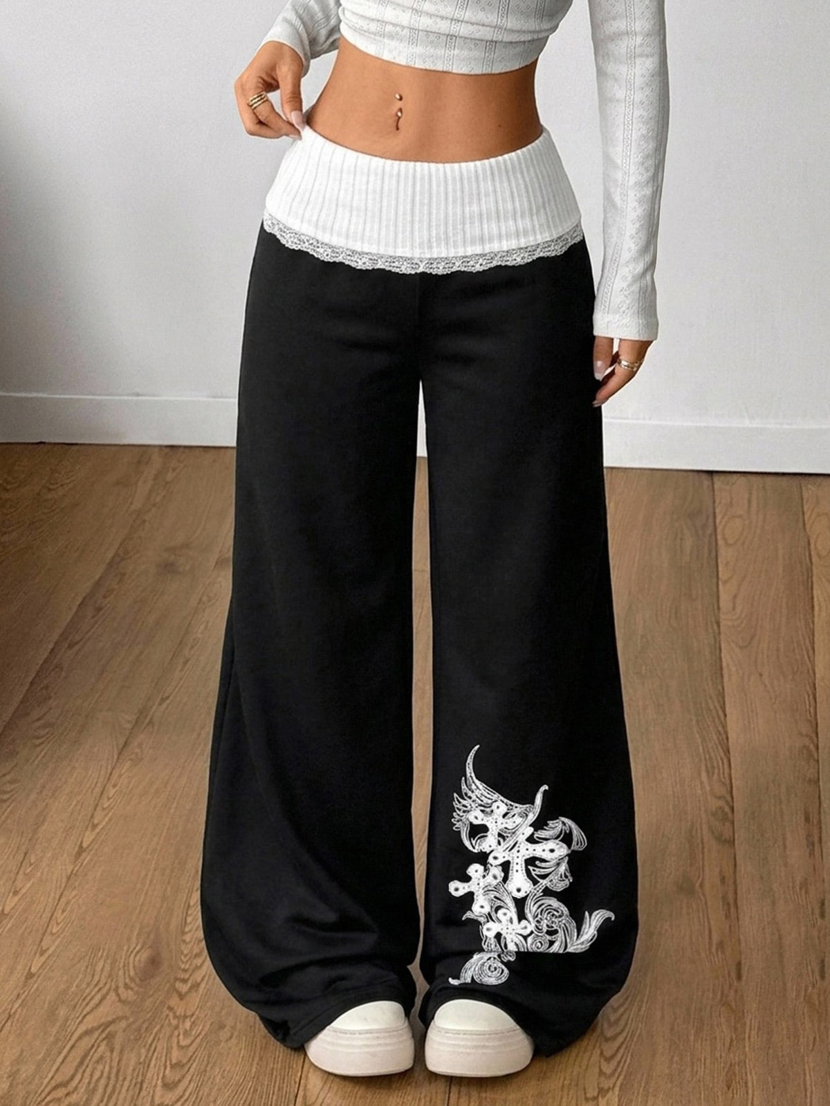 Women's casual straight leg sweatpants featuring a black and white polka dot design with an elastic waistband.