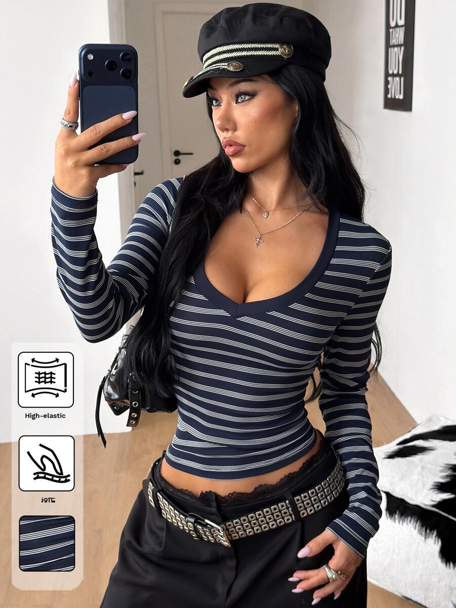 Women's fitted long sleeve rib-knit top featuring a deep V-neckline with delicate contrast lace detailing.