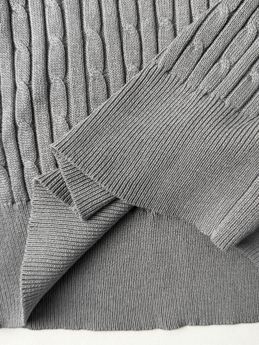 Women's slim fit cable-knit sweater with a V-neckline and long sleeves in solid green rib knit fabric.