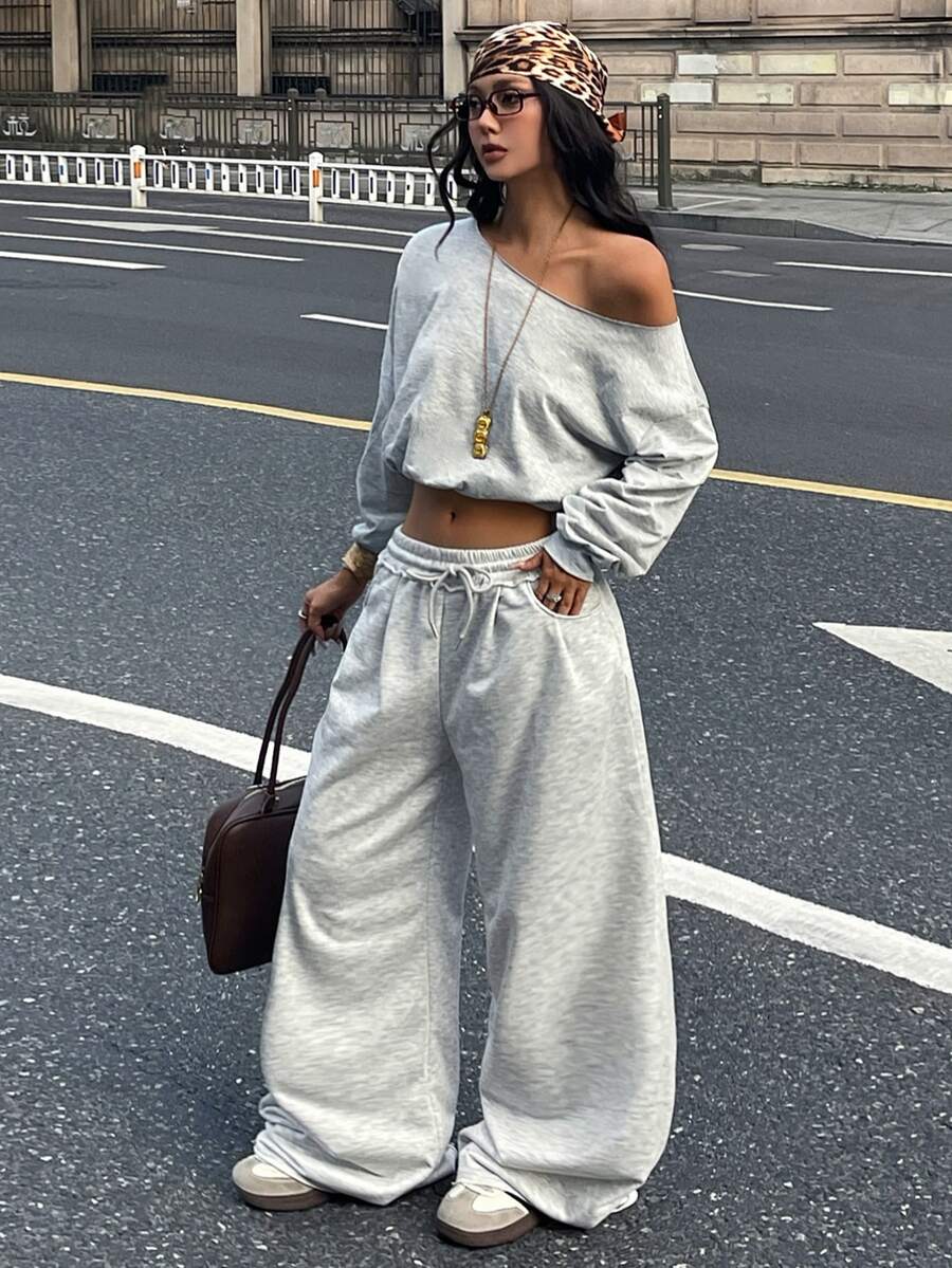 Women's casual straight leg baggy lounge pants in light grey with an adjustable drawstring waist and side pockets.