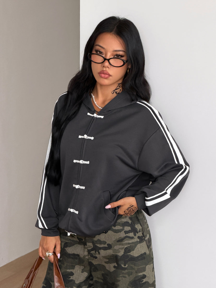 Women's army green camo zip up hoodie with drop shoulder sleeves, front pockets, and drawstring hood