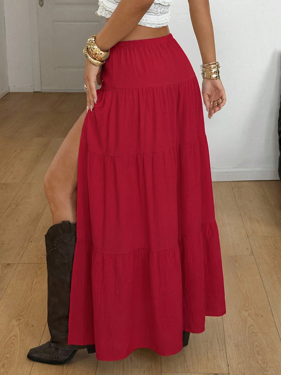 Women's red plaid long skirt featuring a low-rise waist and a side slit in lightweight woven fabric.