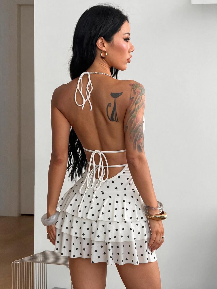 Front view of a women's lace halter mini dress featuring a slim-fit bodice, flared hem, and sleeveless design.