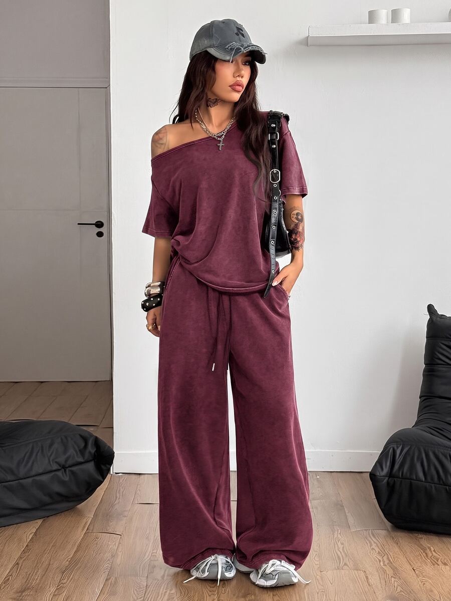 Women's two-piece outfit featuring an oversized asymmetrical neck t-shirt and matching wide-leg drawstring sweatpants.