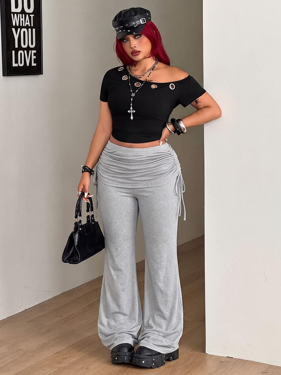 Women's striped flare leg pants featuring a mid-rise waist, slim fit thigh, and ruched side drawstring detail in stretch knit fabric.