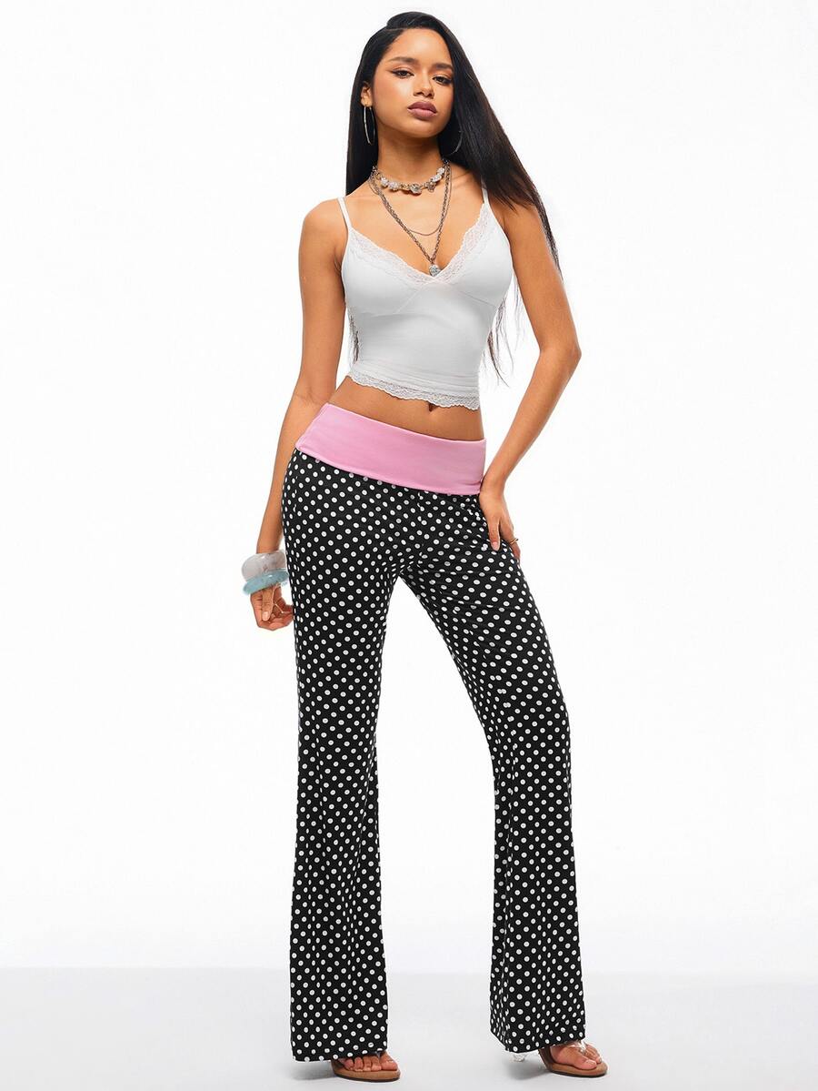 Women's black and white polka dot flare leg pants with side drawstring and ruched details