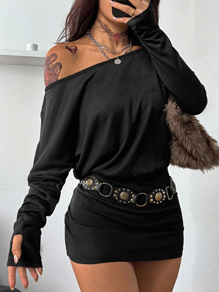 Women's long sleeve bodycon mini dress in black knitted fabric with an asymmetrical neckline and ruched accents.