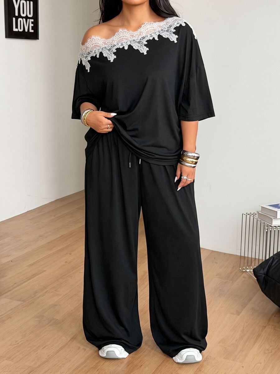 Women's casual two-piece outfit featuring a loose short-sleeve asymmetrical neck t-shirt and matching long wide leg pants with pockets.