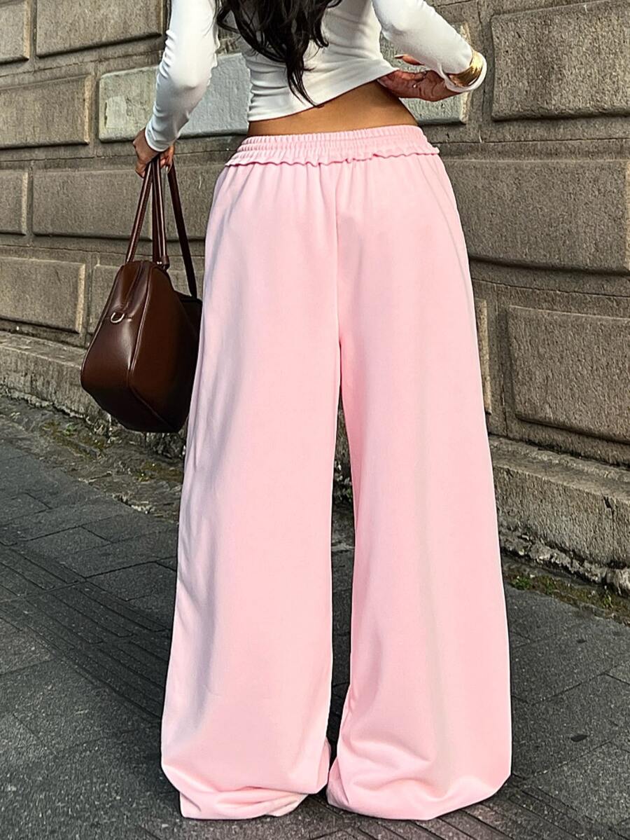 Women's casual straight leg baggy lounge pants in light grey with an adjustable drawstring waist and side pockets.