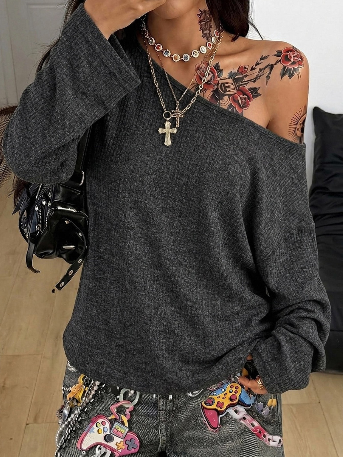 Women's off the shoulder long sleeve t-shirt featuring an asymmetrical neckline and loose fit in soft knitted fabric.