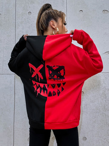 Multicolor women's oversized drawstring hoodie with a cartoon face graphic print, two-tone colorblock design, and drop shoulder long sleeves.