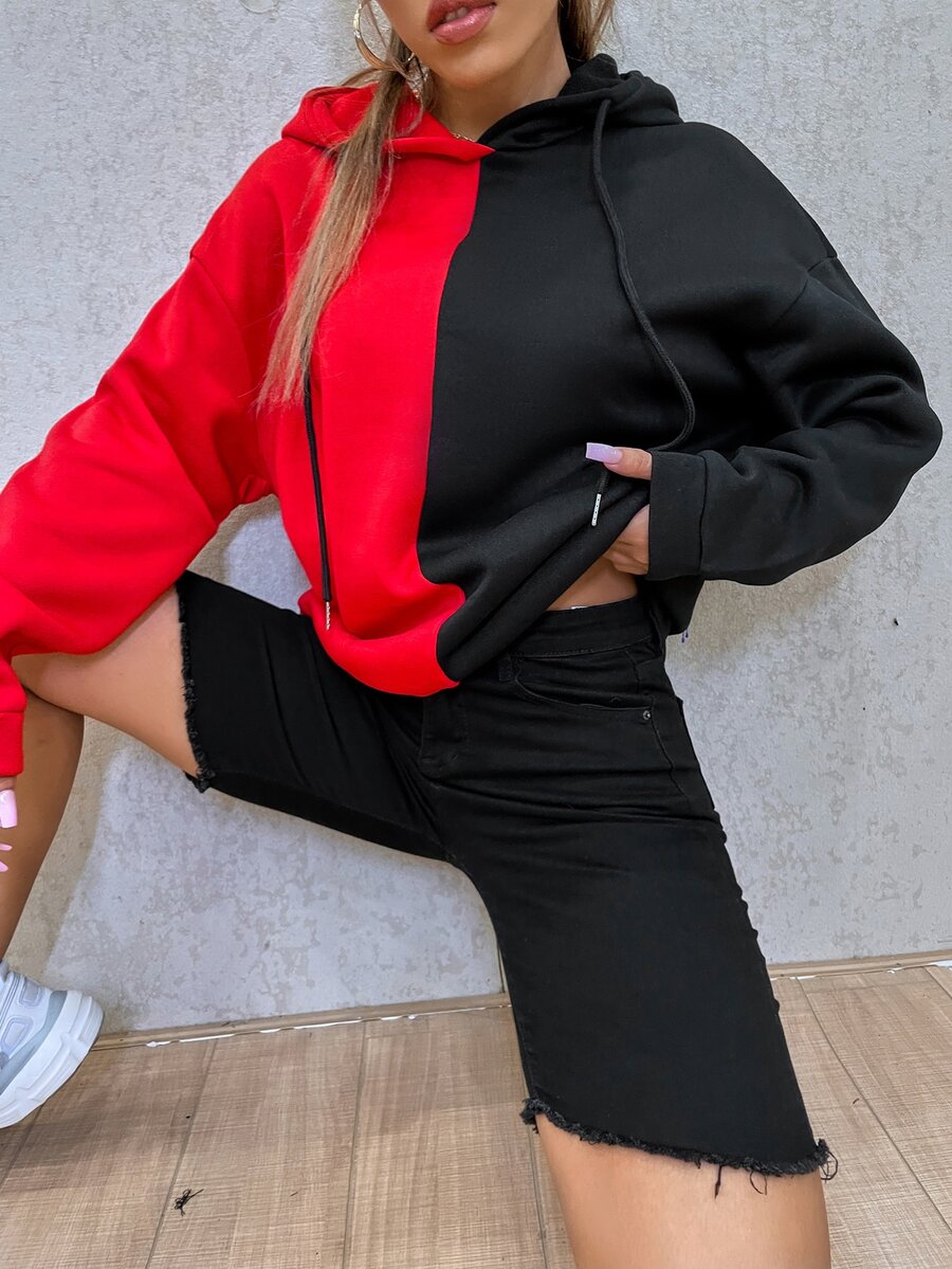 Multicolor women's oversized drawstring hoodie with a cartoon face graphic print, two-tone colorblock design, and drop shoulder long sleeves.