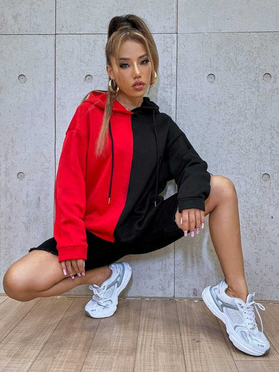 Multicolor women's oversized drawstring hoodie with a cartoon face graphic print, two-tone colorblock design, and drop shoulder long sleeves.