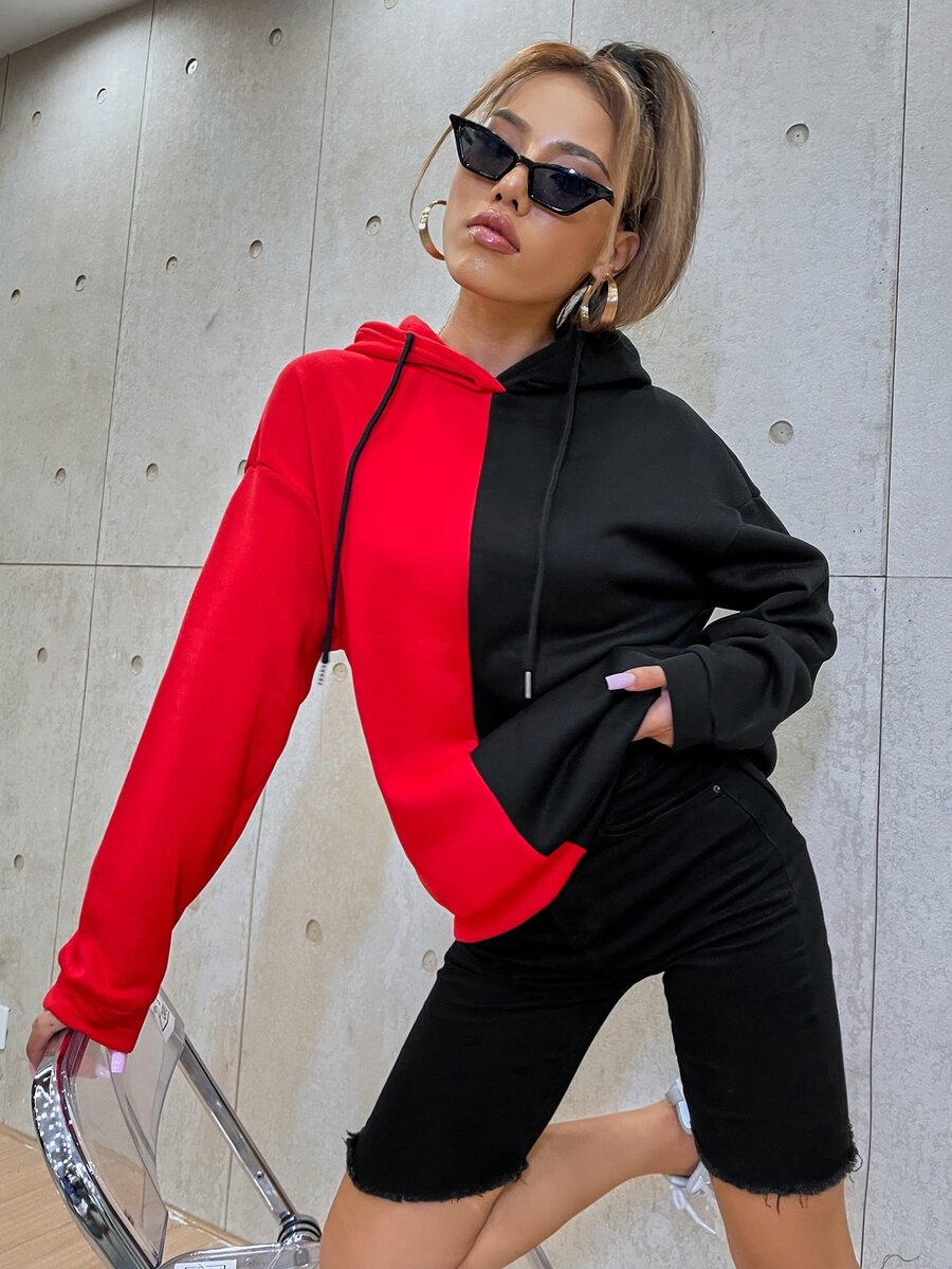 Multicolor women's oversized drawstring hoodie with a cartoon face graphic print, two-tone colorblock design, and drop shoulder long sleeves.
