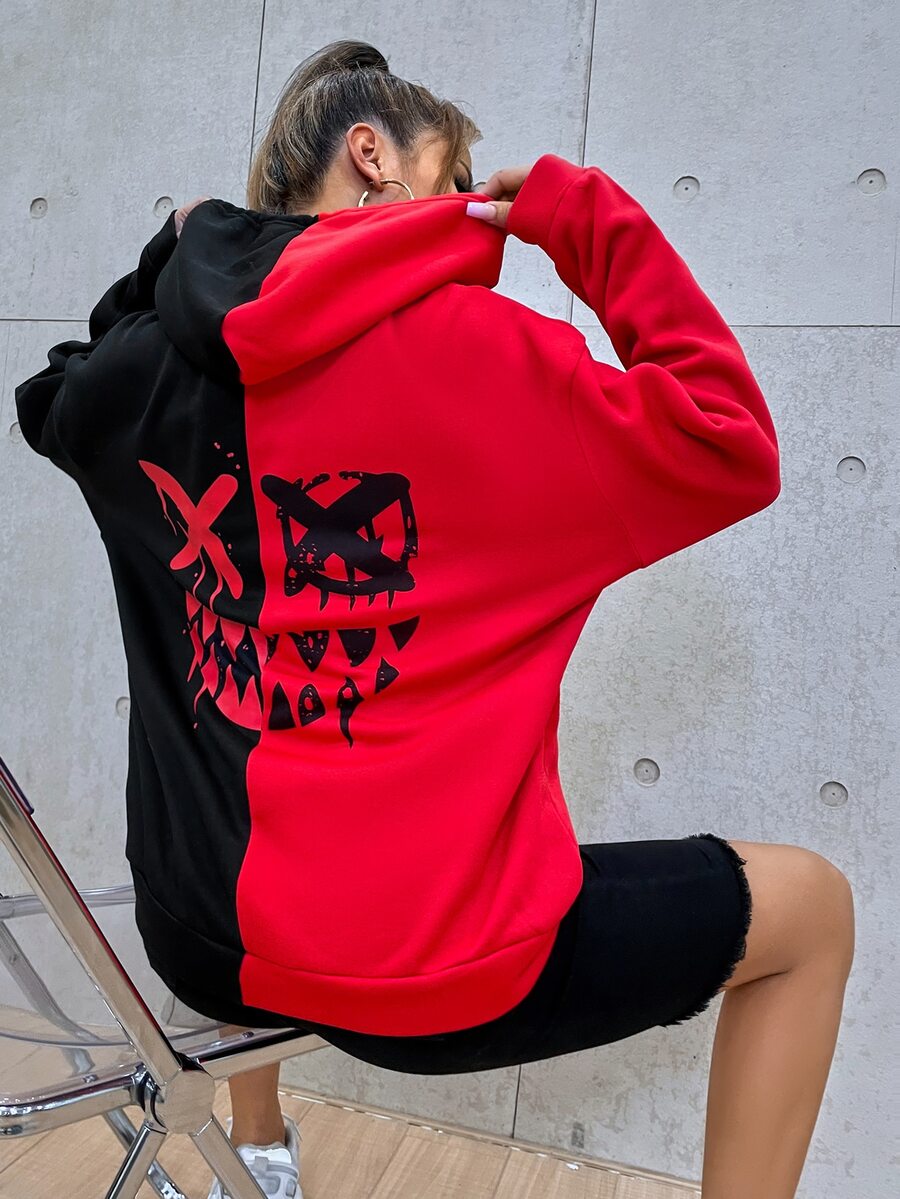 Multicolor women's oversized drawstring hoodie with a cartoon face graphic print, two-tone colorblock design, and drop shoulder long sleeves.