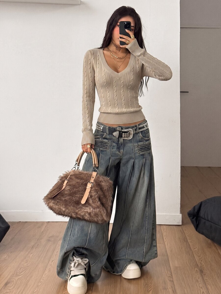 Women's slim fit cable-knit long sleeve sweater featuring a V-neckline and ribbed knit details.