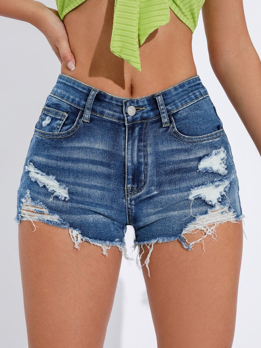 Women's solid color shorts with zipper fly, button closure, pockets, ripped details, and raw hem in a casual straight-leg short length