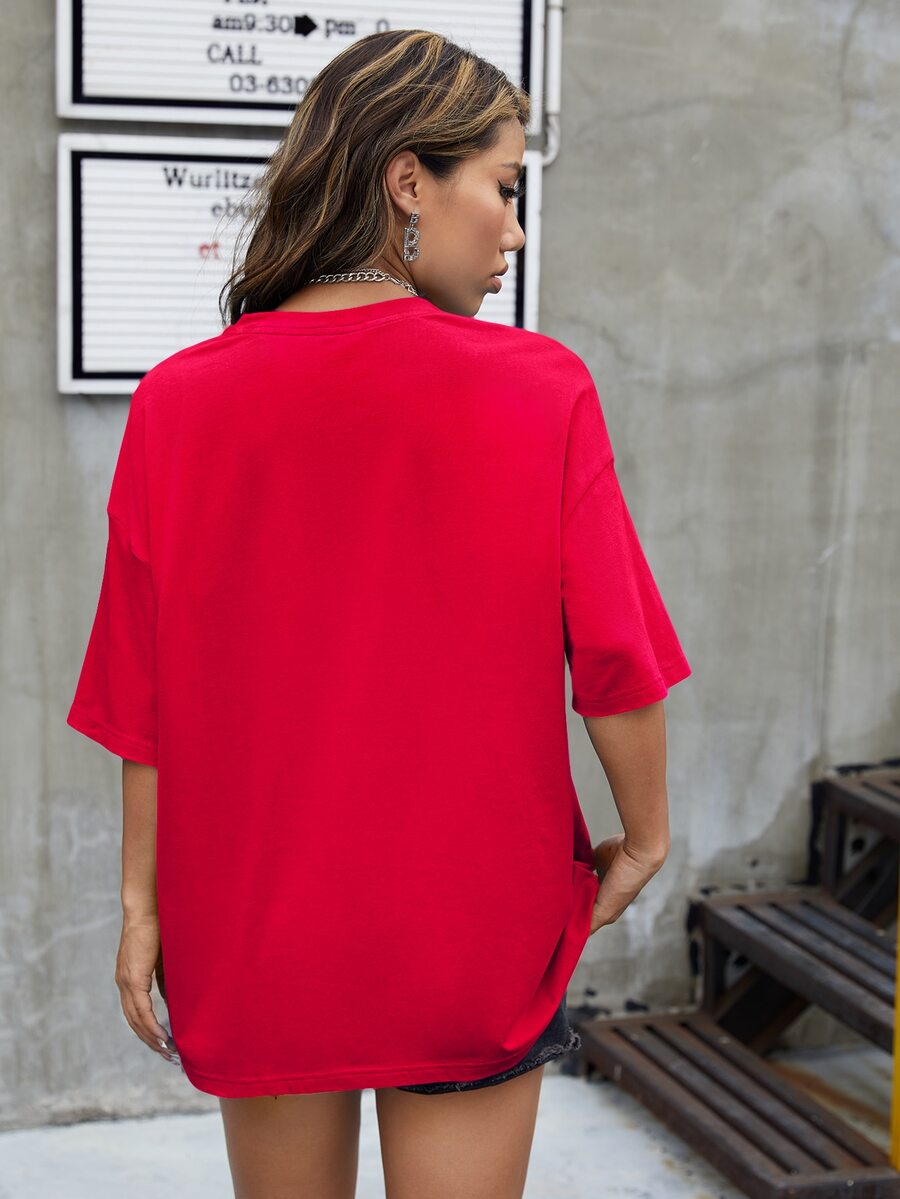 Red oversized t-shirt with letter graphic print and drop shoulder half sleeves.