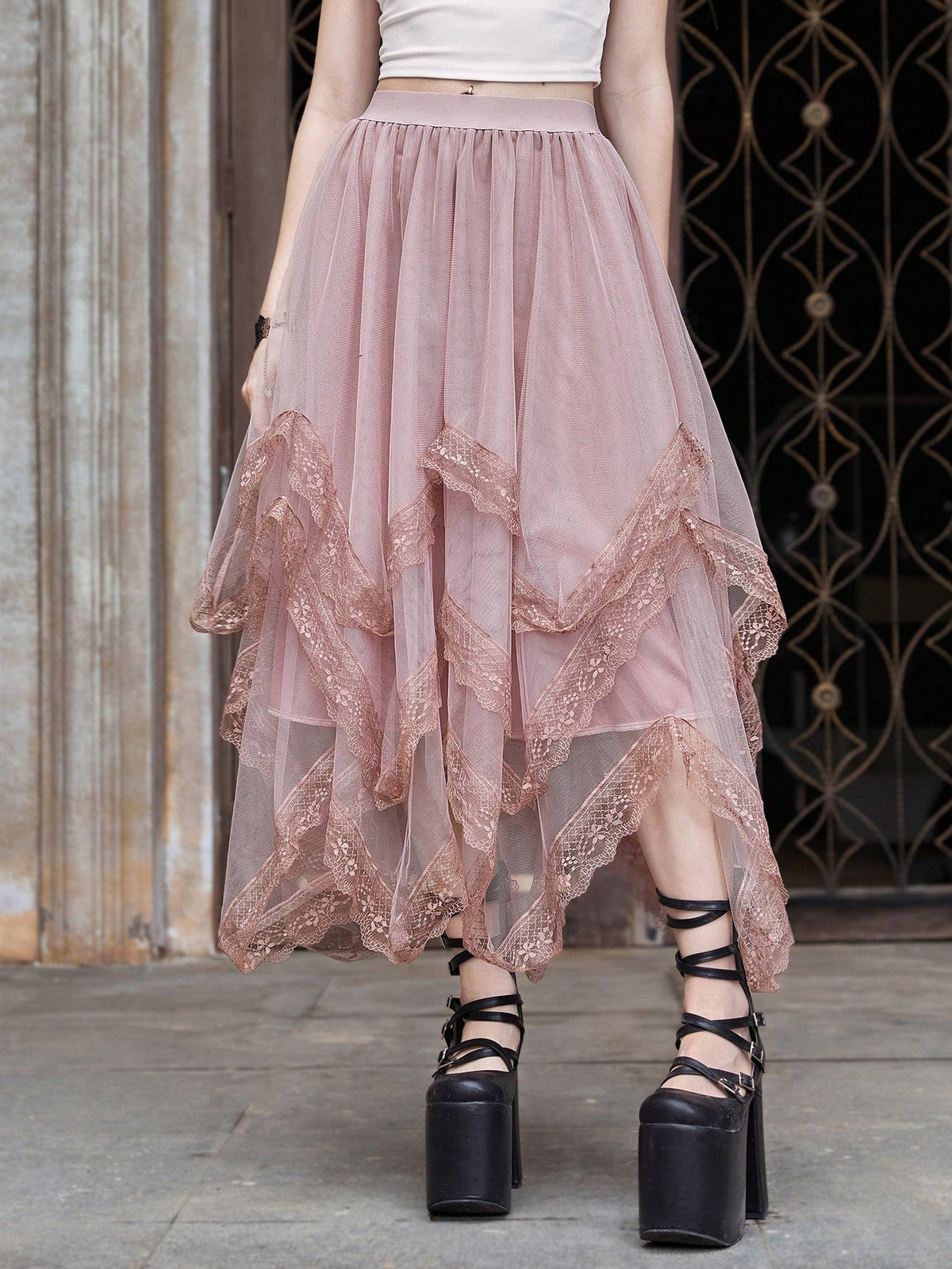 Women's asymmetrical high-waist mesh long skirt featuring contrast lace trim and a tiered A-line silhouette.