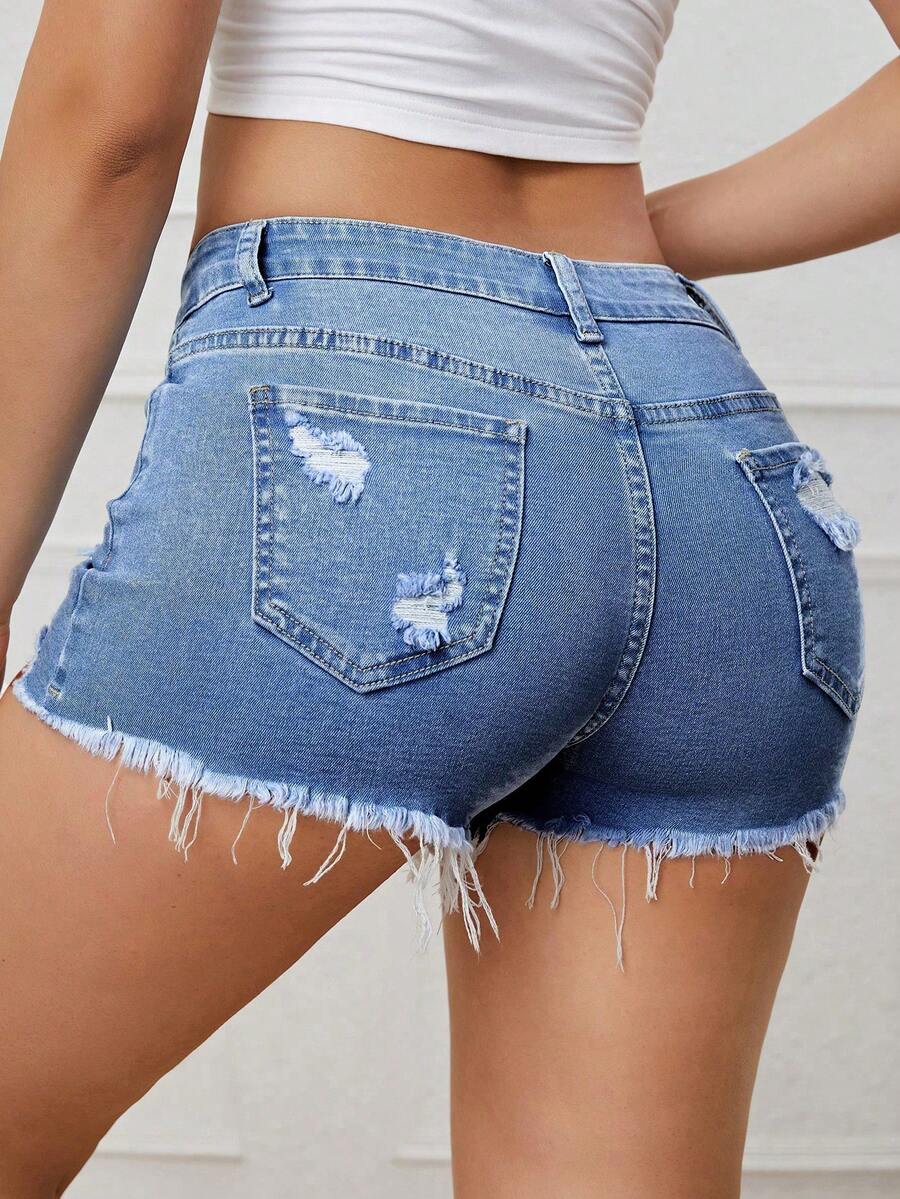 Women's solid color shorts with zipper fly, button closure, pockets, ripped details, and raw hem in a casual straight-leg short length