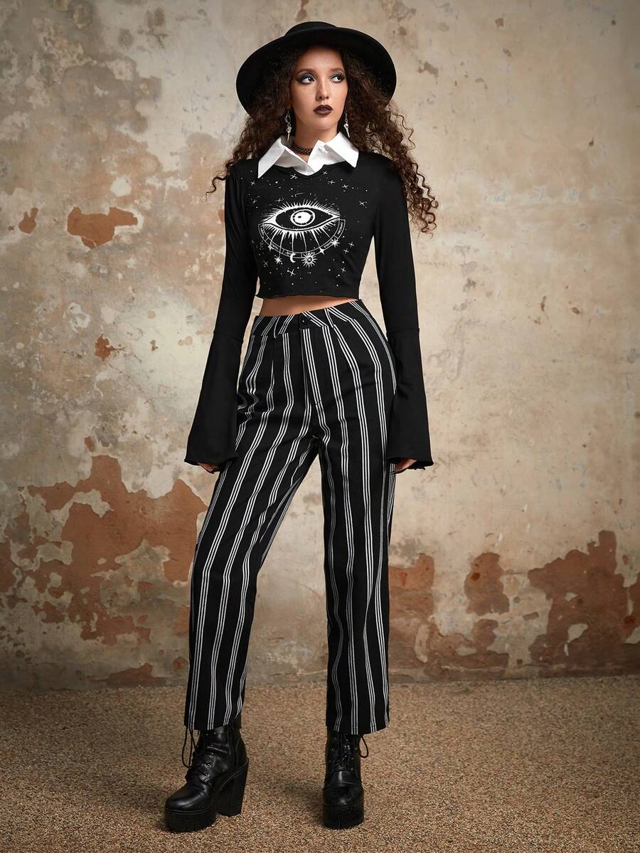 Women's black and white striped straight leg pants featuring a mid waist, regular fit, and zipper fly closure.