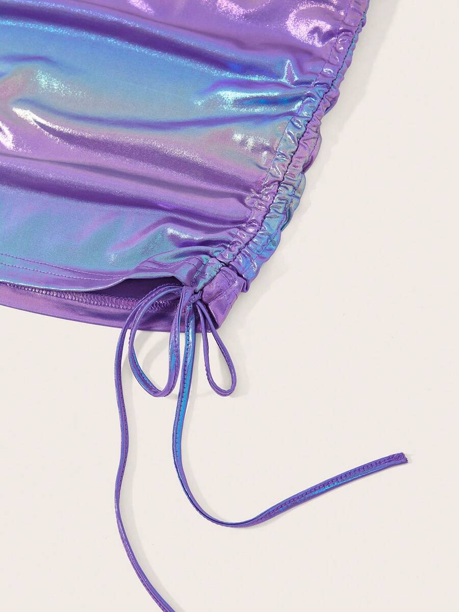 Holographic metallic two-piece set with a spaghetti strap hanky hem crop cami top and drawstring side skirt, featuring ruched details and rhinestone accents.