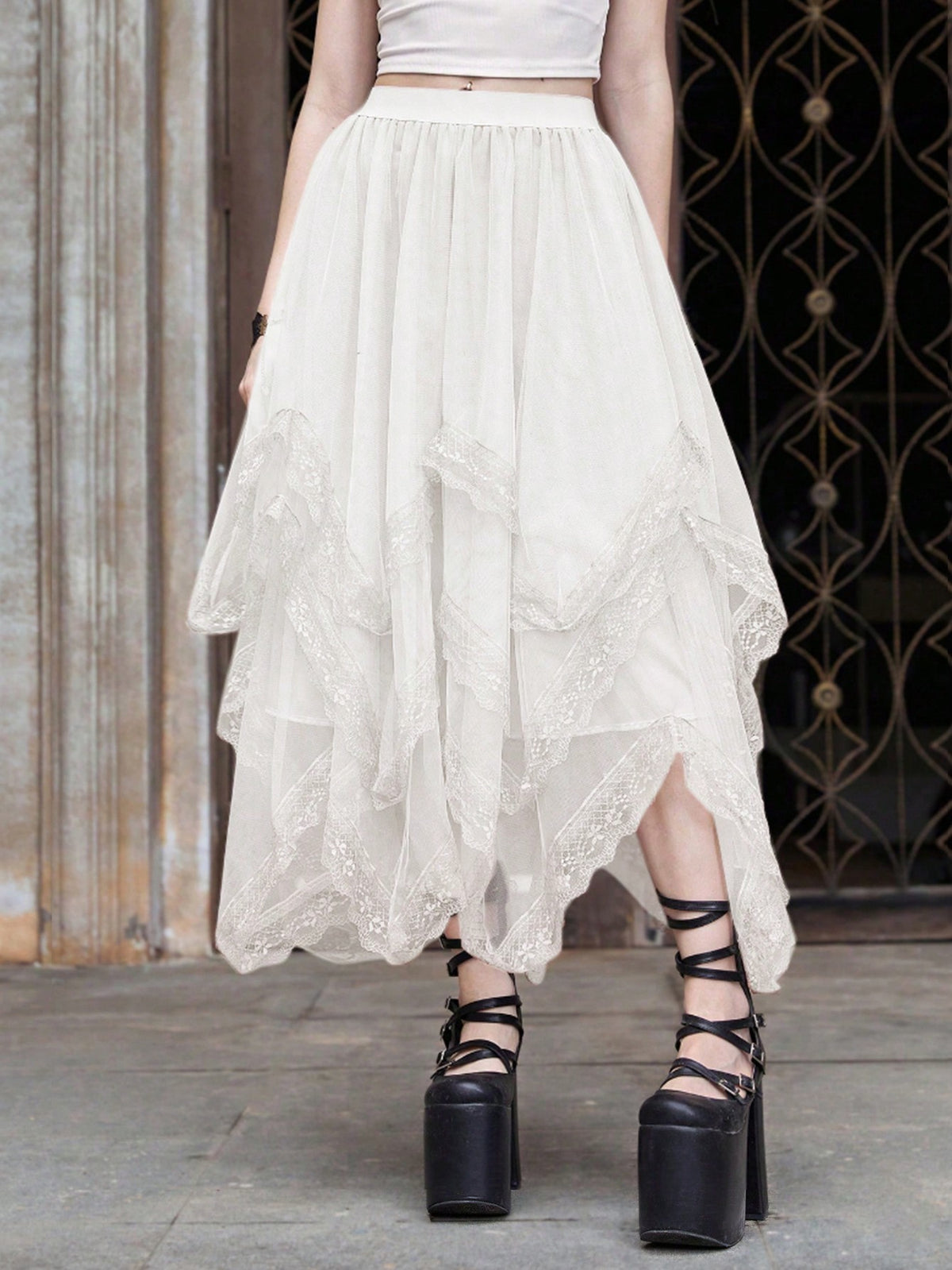 Women's asymmetrical high-waist mesh long skirt featuring contrast lace trim and a tiered A-line silhouette.