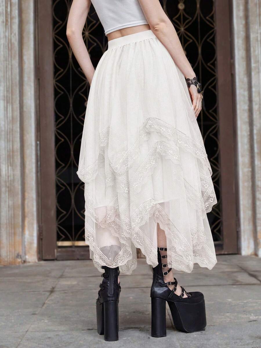Women's asymmetrical high-waist mesh long skirt featuring contrast lace trim and a tiered A-line silhouette.