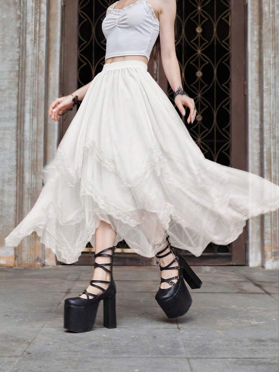Women's asymmetrical high-waist mesh long skirt featuring contrast lace trim and a tiered A-line silhouette.