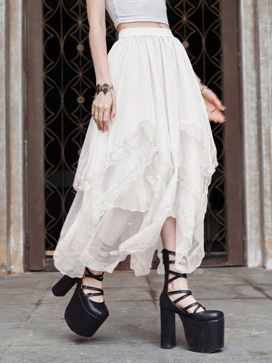 Women's asymmetrical high-waist mesh long skirt featuring contrast lace trim and a tiered A-line silhouette.