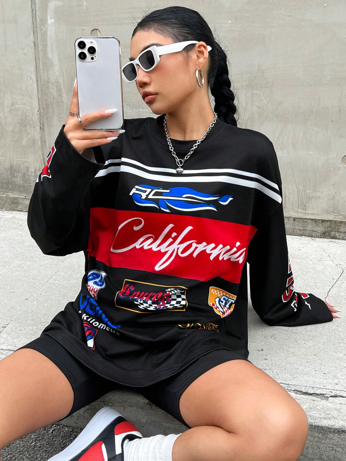 Women's black loose-fit long sleeve blokecore football t-shirt featuring color block stripes, letter print, and drop shoulders.