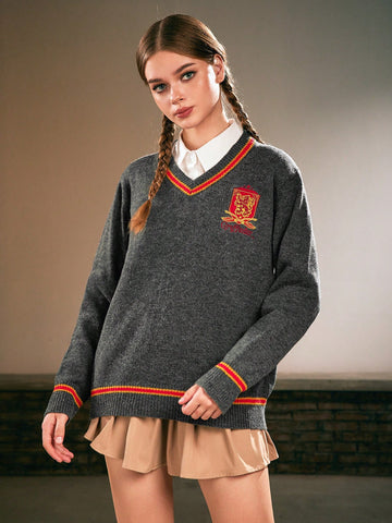 Women's grey V-neck knit pullover sweater featuring drop shoulder long sleeves, striped contrast trim along the neckline, and chest embroidery.