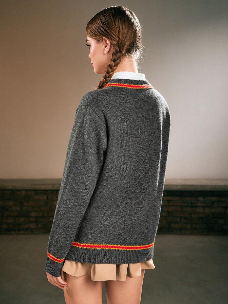 Women's grey V-neck knit pullover sweater featuring drop shoulder long sleeves, striped contrast trim along the neckline, and chest embroidery.