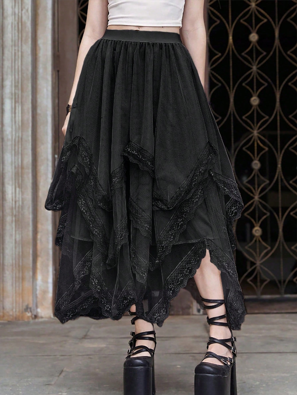 Women's asymmetrical high-waist mesh long skirt featuring contrast lace trim and a tiered A-line silhouette.