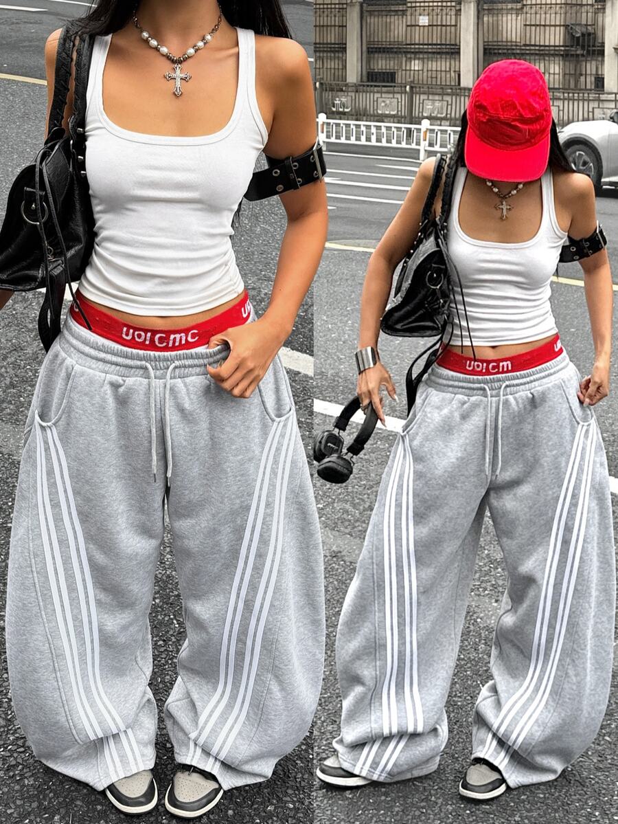 Women's casual grey plaid sweatpants featuring an elastic drawstring waistband, side pockets, and a relaxed loose fit.